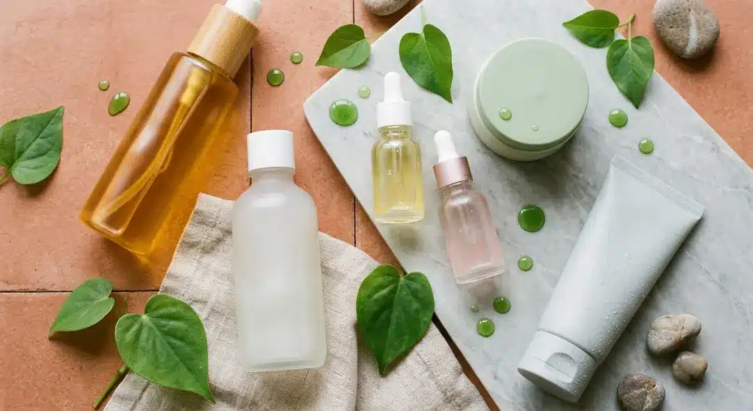 Top down view of gentle Korean skincare products on a warm terracotta background.